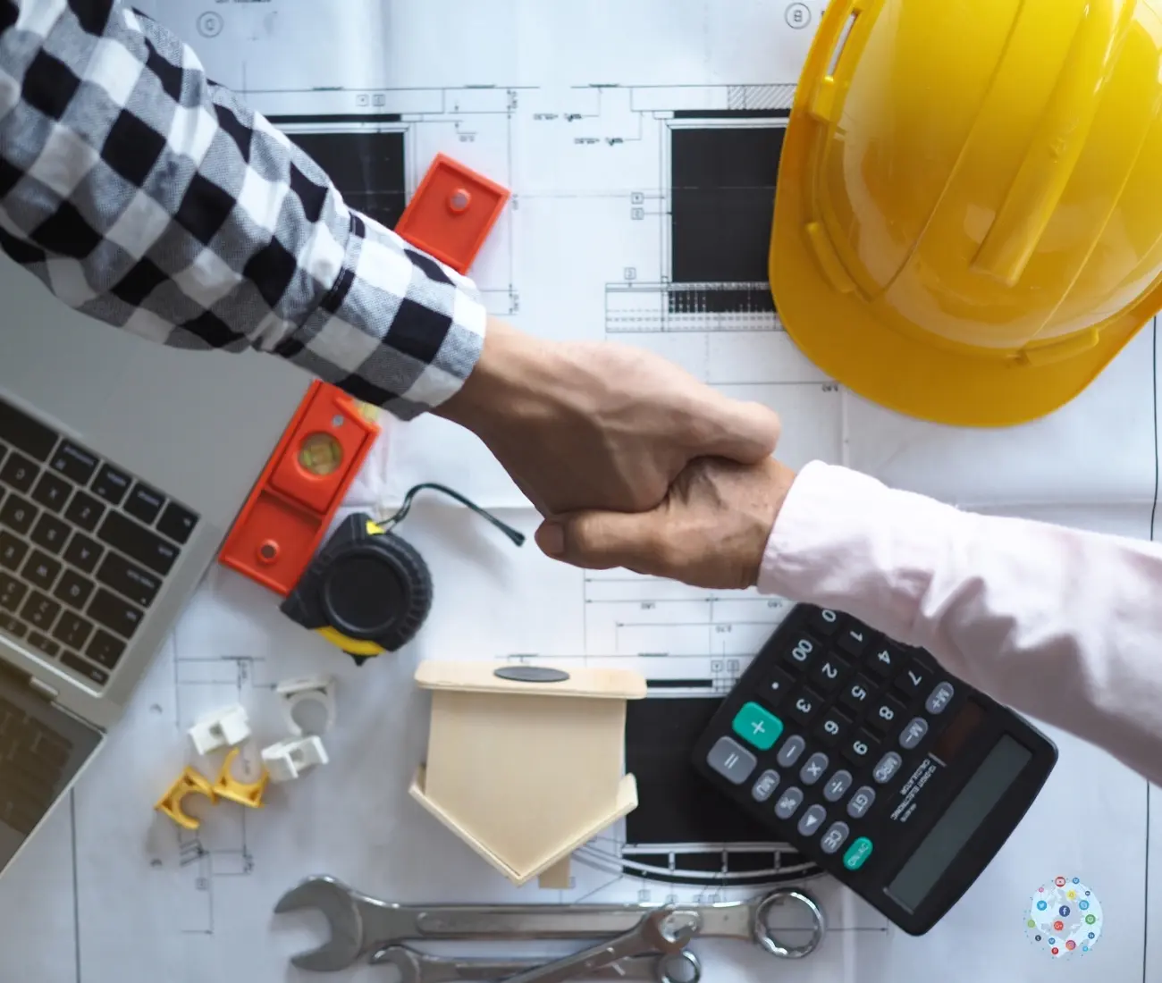 hand shake Handshake between contractor and marketing partner over construction blueprints, symbolizing trust and business partnership in the home services industry.